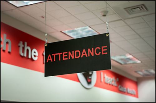 Attendance sign hanging from ceiling